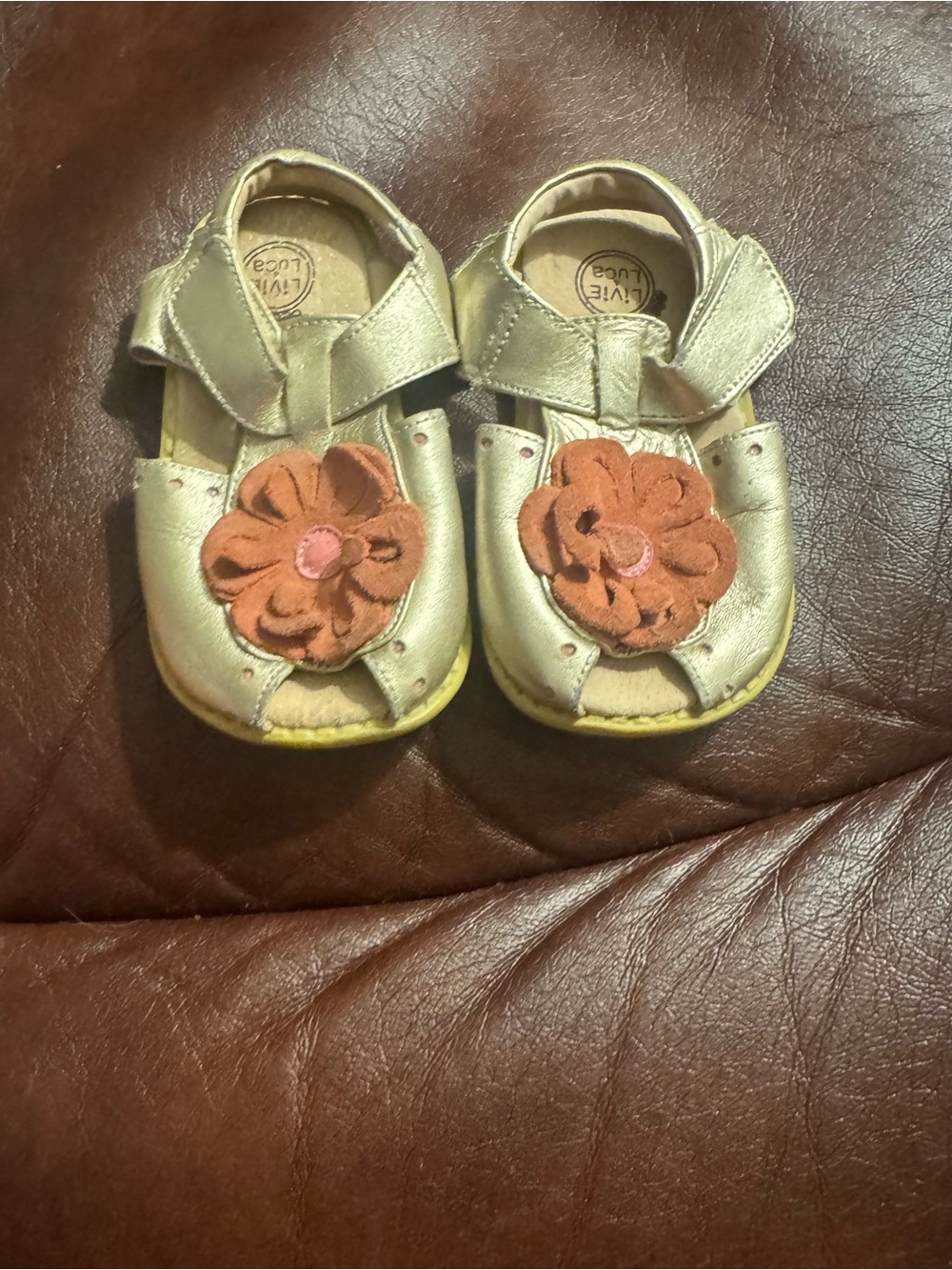 Livie & Luca Metallic Gold Leather Sandals with Flower Accent